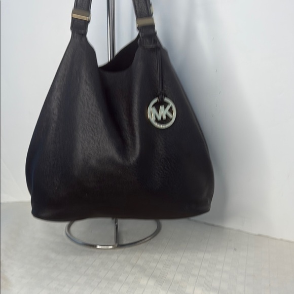 The image shows a Michael Kors Colgate Reversible Grab Bag in black. - Picture 1 of 11